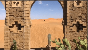 Photo of the Sahara desert through a brick arch and a cantus in the centre