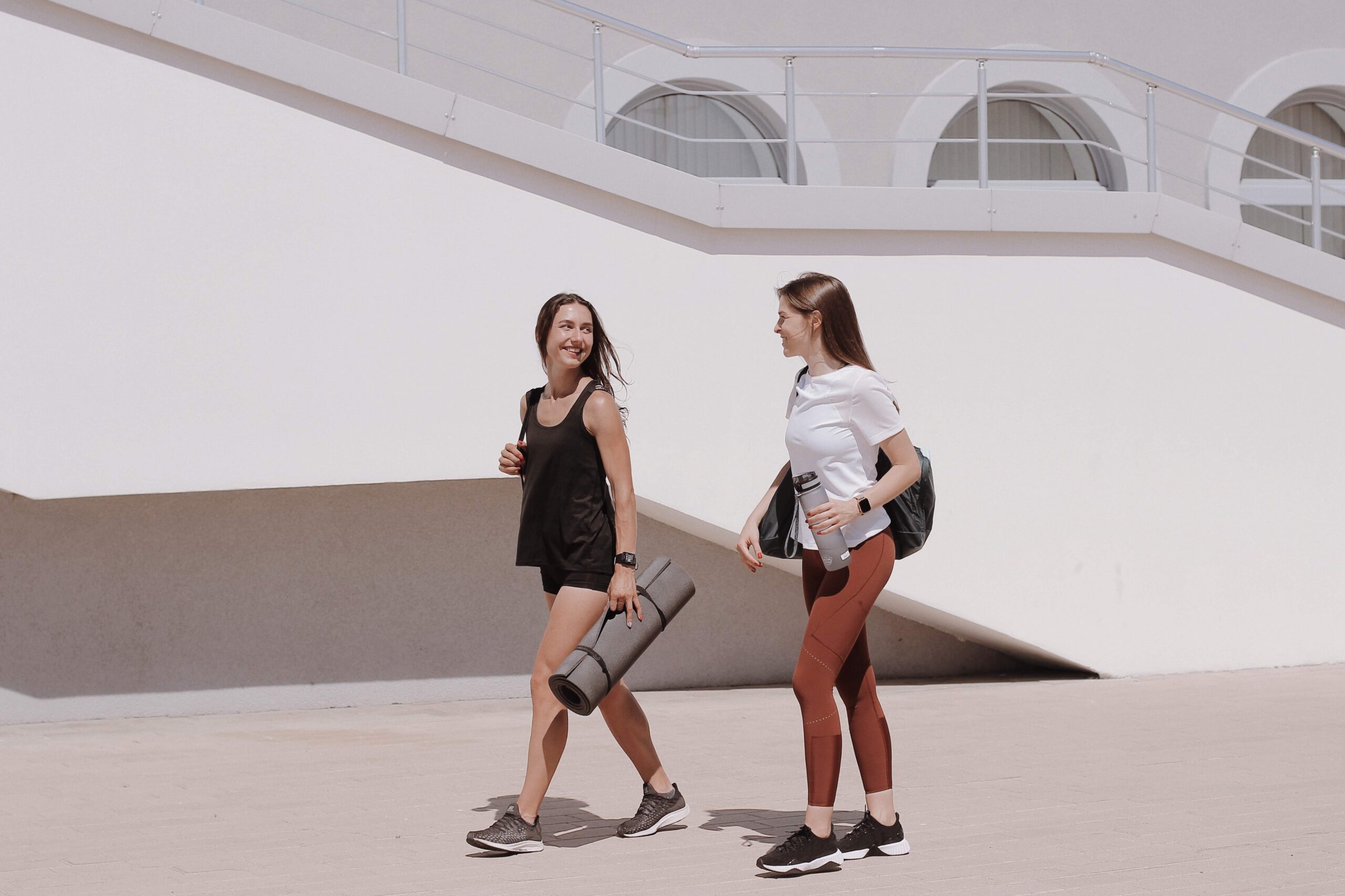 Two girls walking with gym gear-Maksim Goncharenok